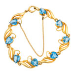 14 Karat Gold Swirl Bracelet with 8 Heart Shaped Synthetic Spinels